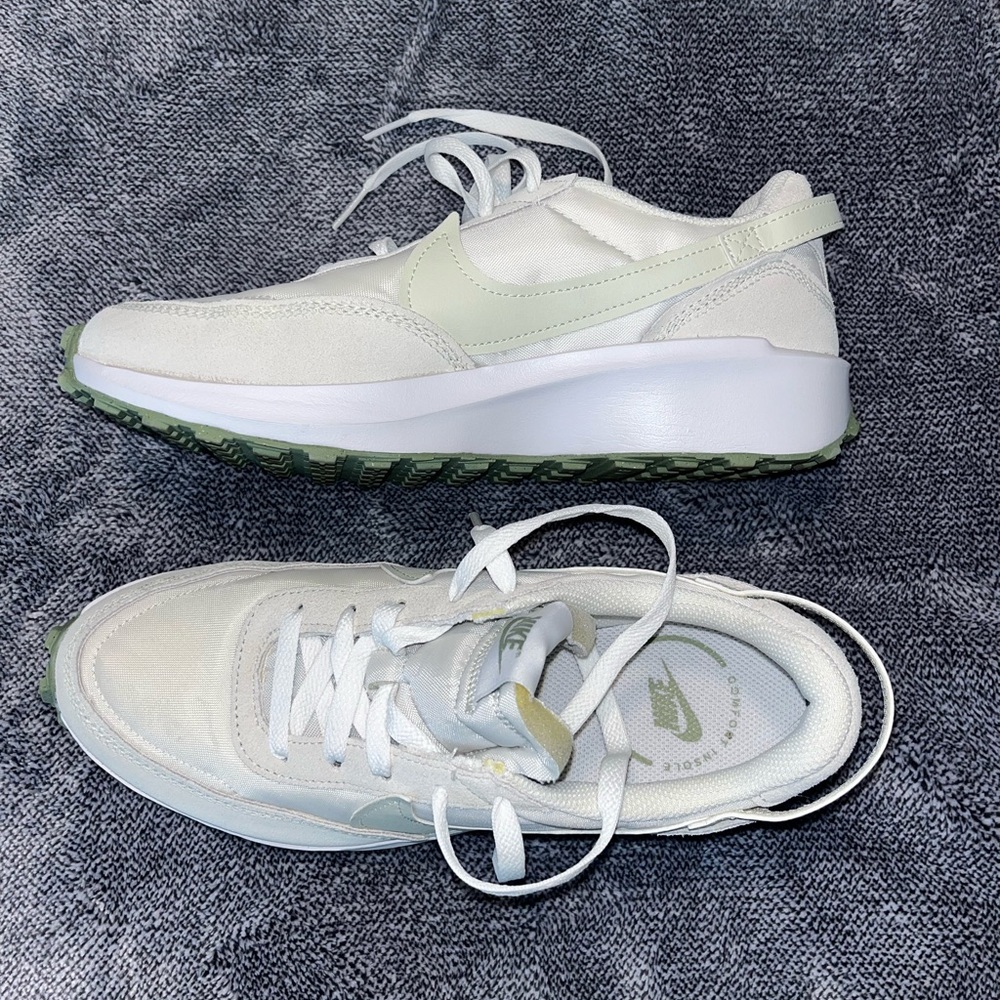 Green and white Nike tennis shoes